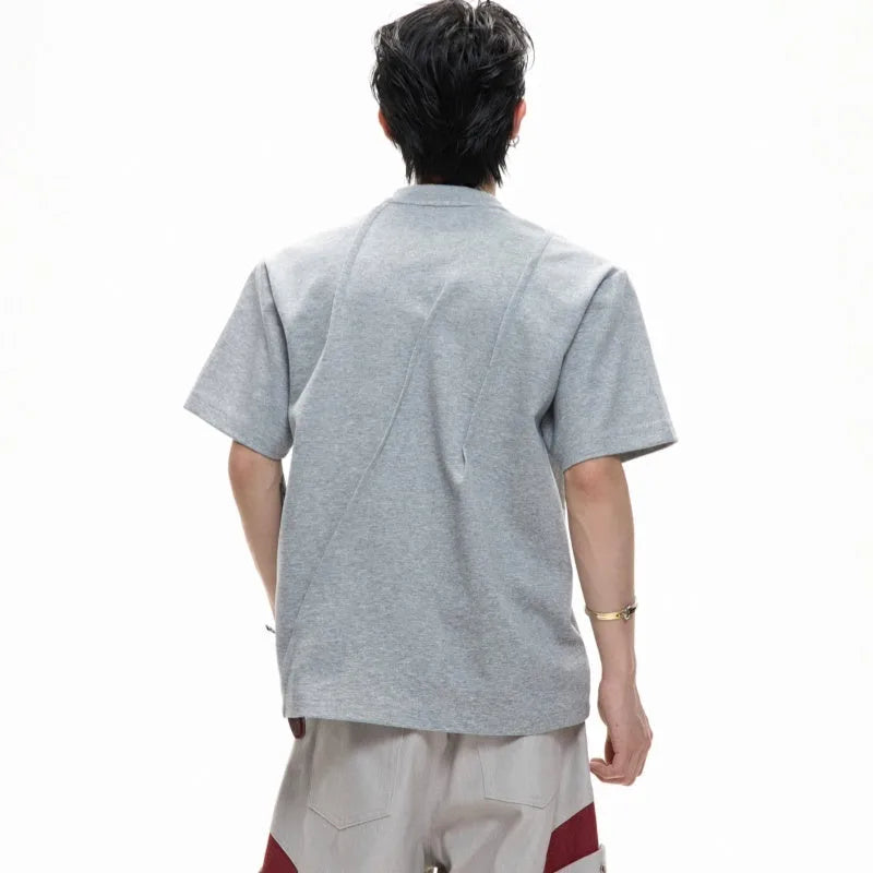 Men's loose fit pleated cotton T-shirt in solid colour with round neck and short sleeves.