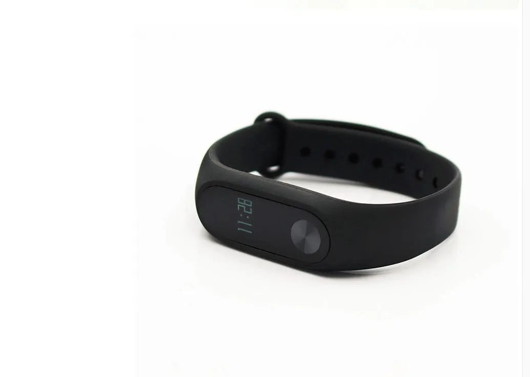 Xiaomi Mi Band 2 black smart fitness tracker with OLED touchscreen display on a wrist.