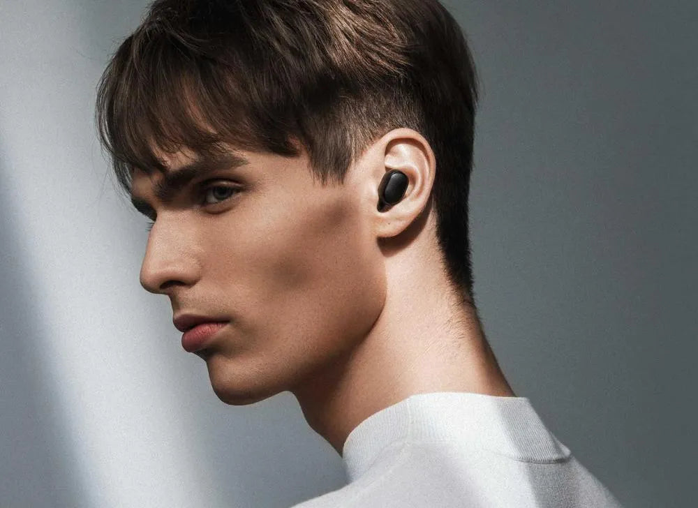 Redmi AirDots True Wireless black earbuds and charging case on a white background.
