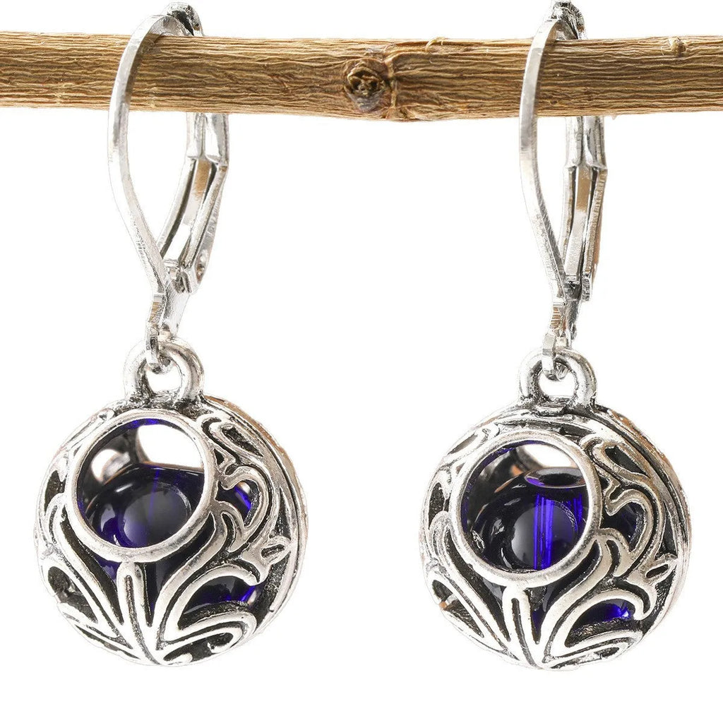Vintage silver hollow pendant earrings with blue gemstone accent on geometric drop shape