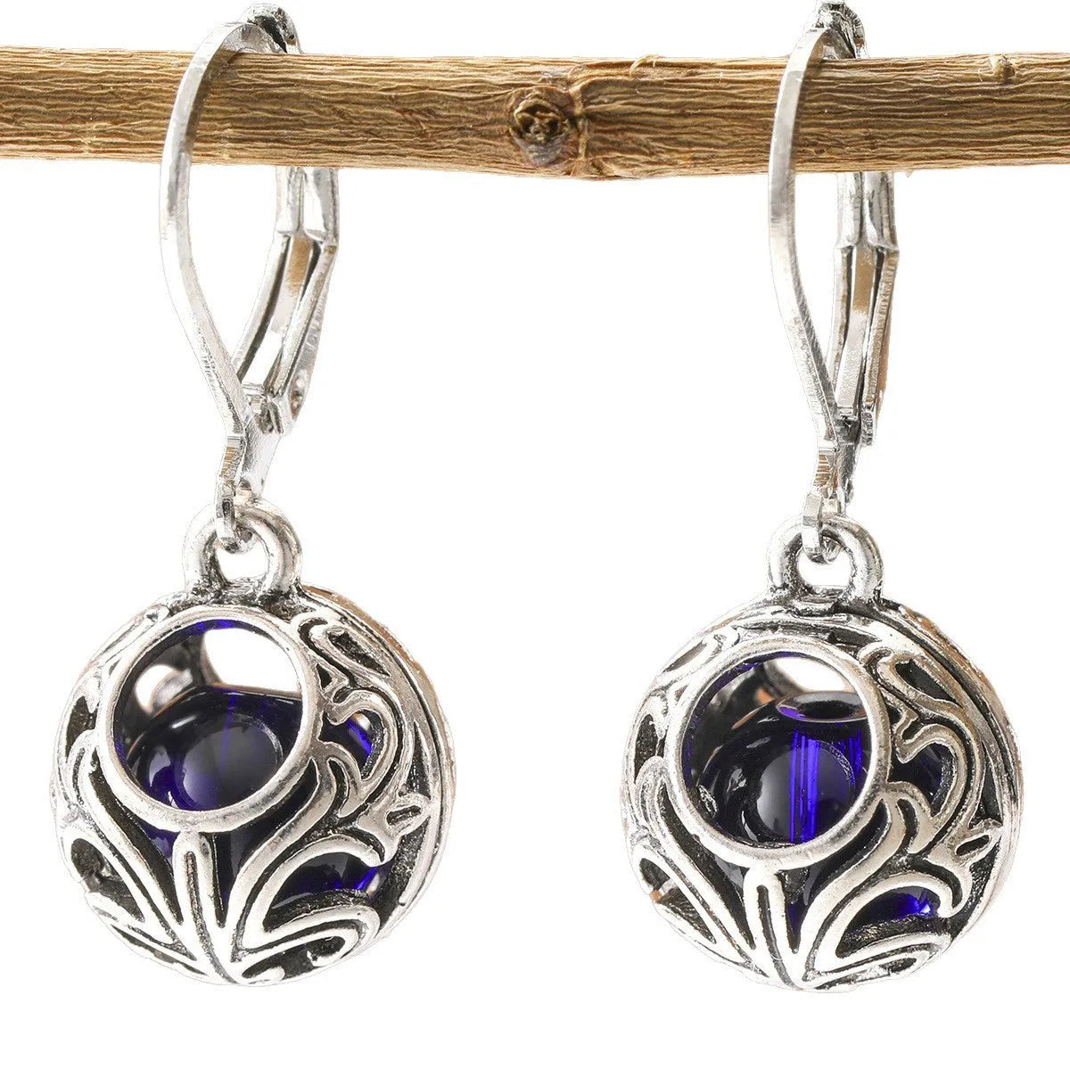 Vintage silver hollow pendant earrings with blue gemstone accent on geometric drop shape