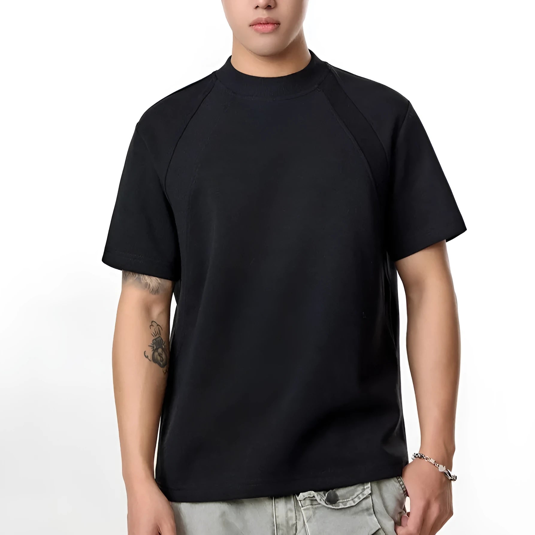 Men's black loose-fit short sleeve top with textured air layer stitching detail.