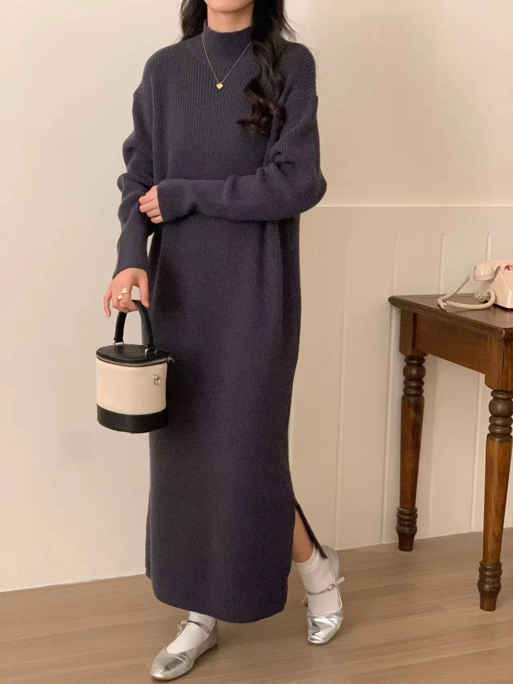 Acrylic knitted half turtleneck dress in beige colour with long sleeves and high waist midi skirt.