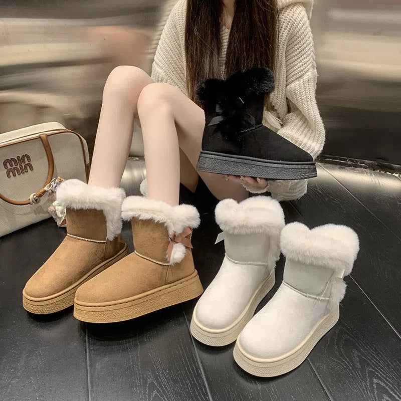 Women's mid-calf fleece-lined snow boots in brown with black rubber sole and bow tie detail