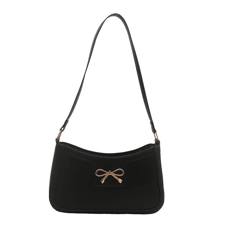 PU leather baguette bag with bow decoration in rose red colour, 24x14x5 cm size on white background