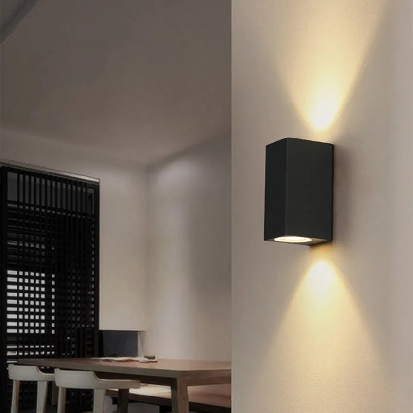 Modern aluminium and glass LED wall lamp in a black finish with silicone rubber trim.