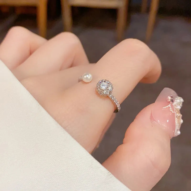 Women's open-end pearl ring with round zircon on geometric copper design in gold plating
