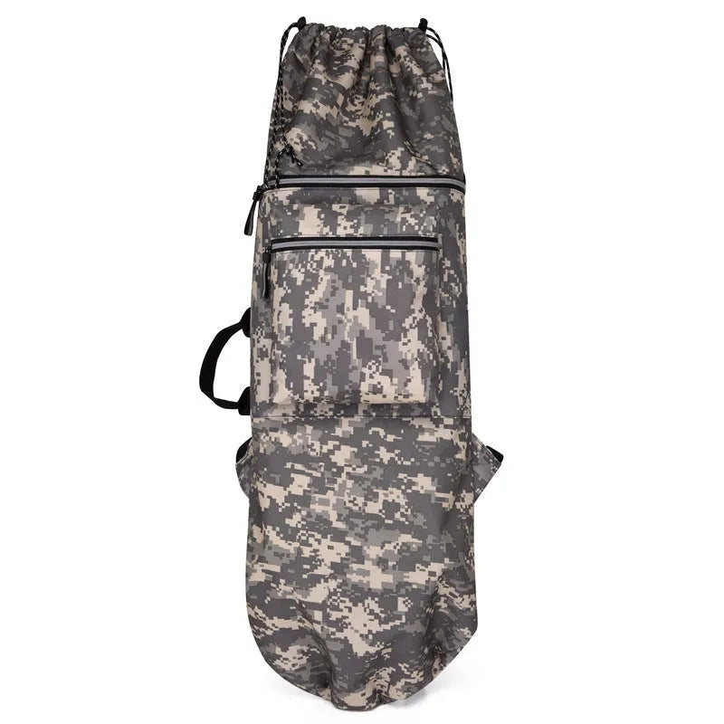 Large black nylon skateboard backpack with straps, shown next to a skateboard on grass.