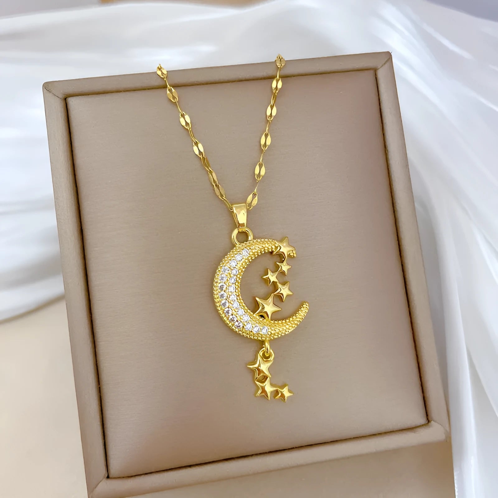Geometric moon pendant necklace with tassel detailing in stainless steel and copper construction