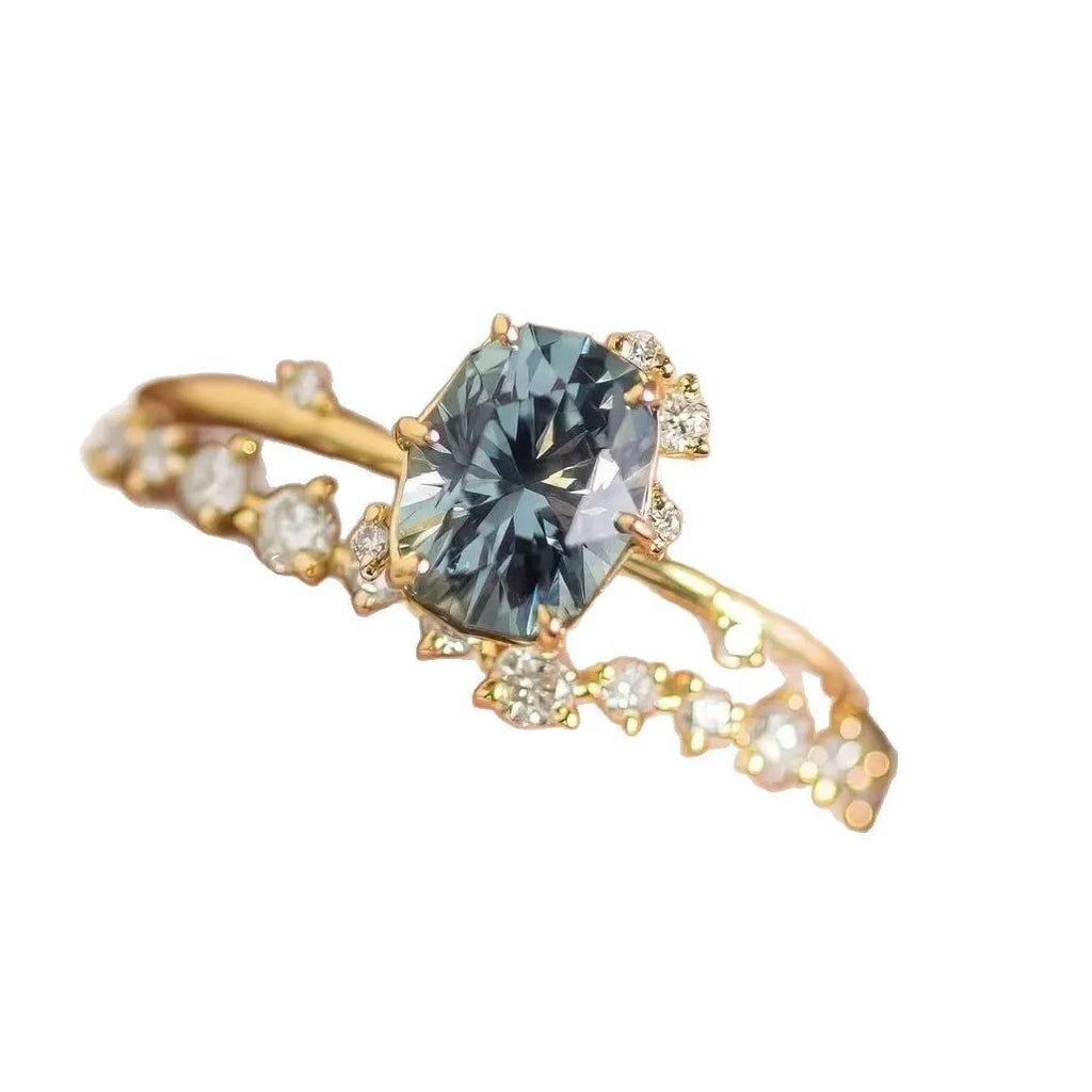 Gold-plated flower-shaped ring with green zircon stones on a model finger