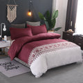 Polyester quilt cover set with edging craft, plain weave, in wine red colour on a bed