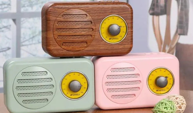 T1 portable Bluetooth speaker in wood grain pink with vintage finish, compact size, and FM radio support