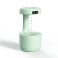 Anti gravity levitating water drops humidifier with LED night light, rose gold white, on desk