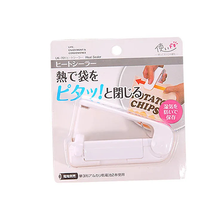 Pink household food clip portable mini plastic bag heat sealer on white background