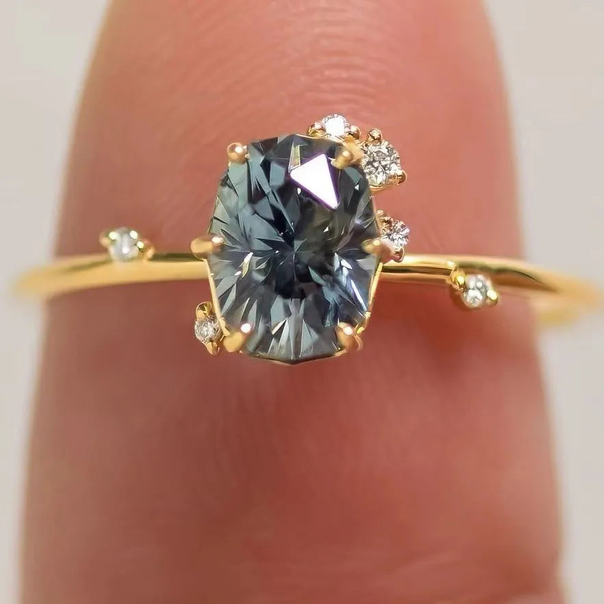 Gold-plated flower-shaped ring with green zircon stones on a model finger