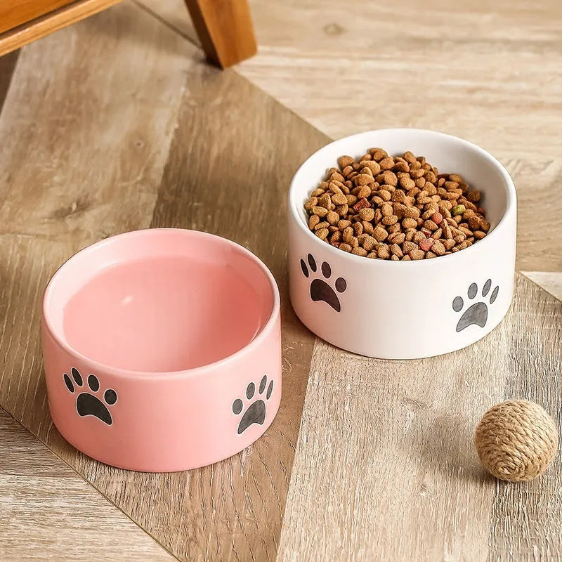 Ceramic cat bowl with oblique mouth and high foot, available in cat's paw colours pink, yellow, black, white