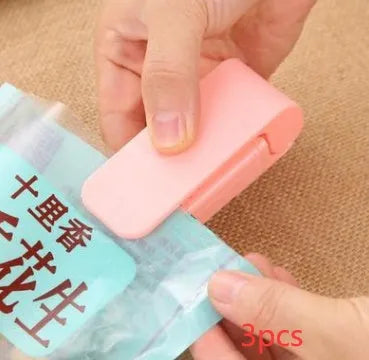 Pink household food clip portable mini plastic bag heat sealer on white background