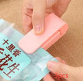 Pink household food clip portable mini plastic bag heat sealer on white background