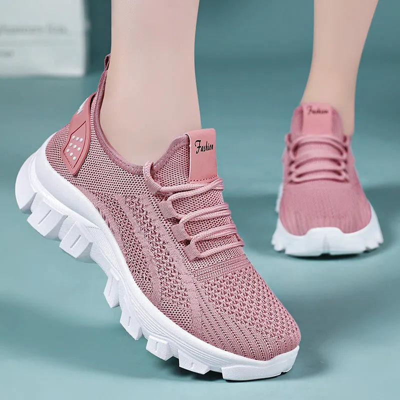 Women's white Flyknit running shoes with a thick PVC sole and lace-up front.