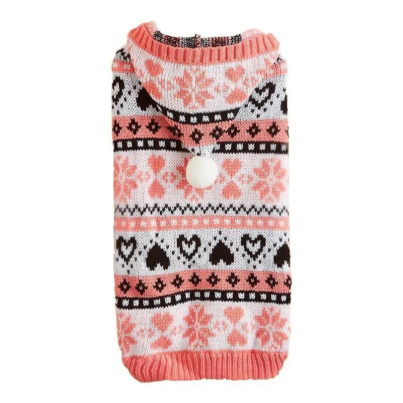 Blue knitted dog sweater with snowflake and camouflage patterns on a small white dog.