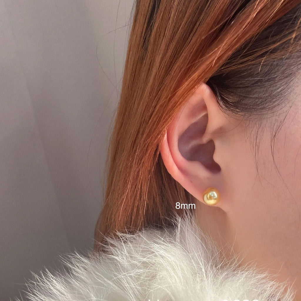 Large geometric pearl stud earrings with retro styling and eight-point star detail in silver