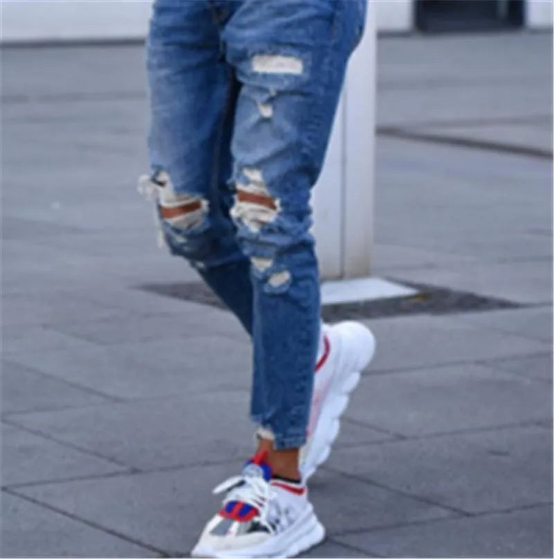 Men's distressed jeans with holes in deep blue cotton denim fabric