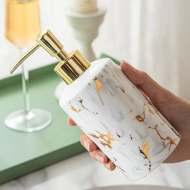 White marble ceramic bathroom wash kit with two cups, latex bottle, and soap box on a counter