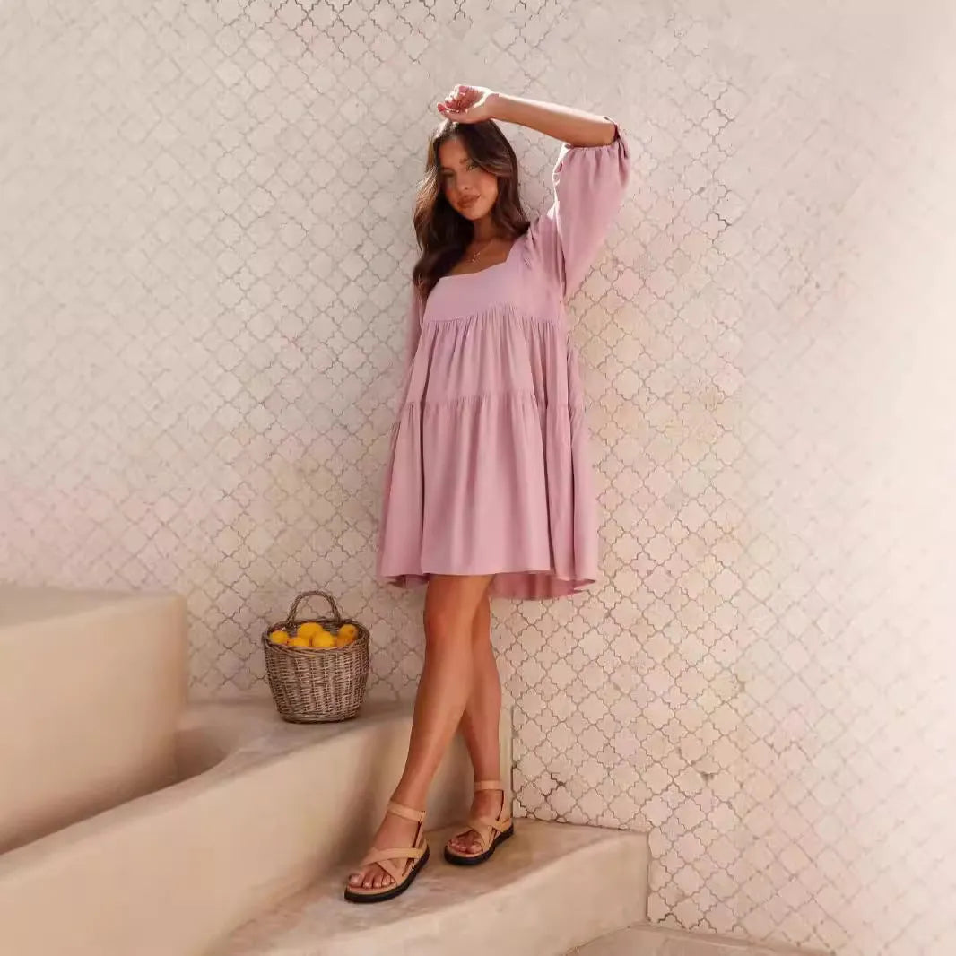Orange children's backless dress with square collar and puff sleeves, showing A-line skirt.