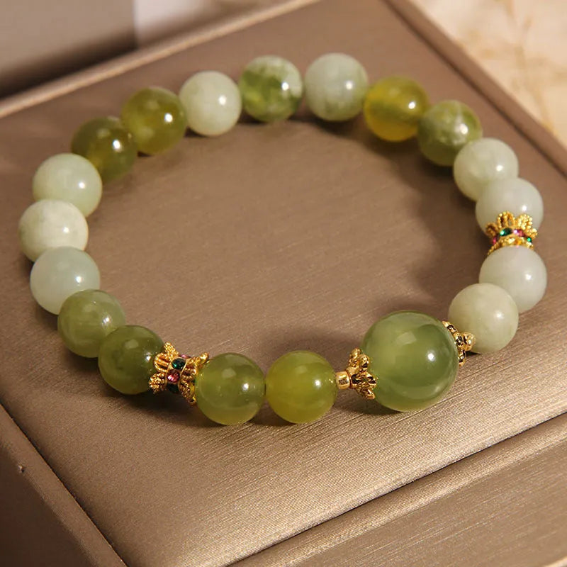 Women's bracelet in Xiuyan jade green with original design on display