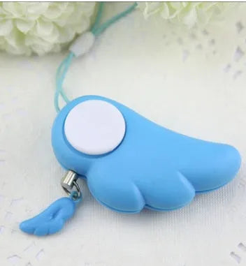 Blue personal security alarm with clip and pull pin on a grey handbag strap