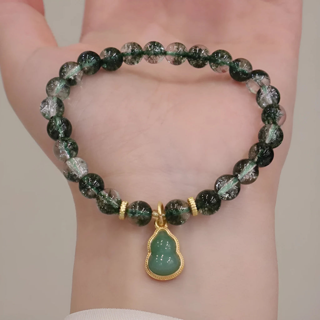 Natural green phantom quartz heart pendant women's crystal bracelet with pearl accents on white background
