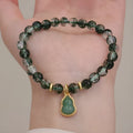 Natural green phantom quartz heart pendant women's crystal bracelet with pearl accents on white background