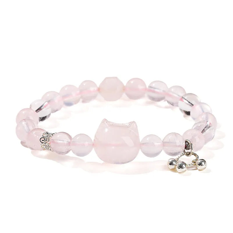 Natural star pink crystal cat head bracelet on a woman's wrist