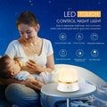 White touch-control bedside night light with RGB colour changing on a wooden table.