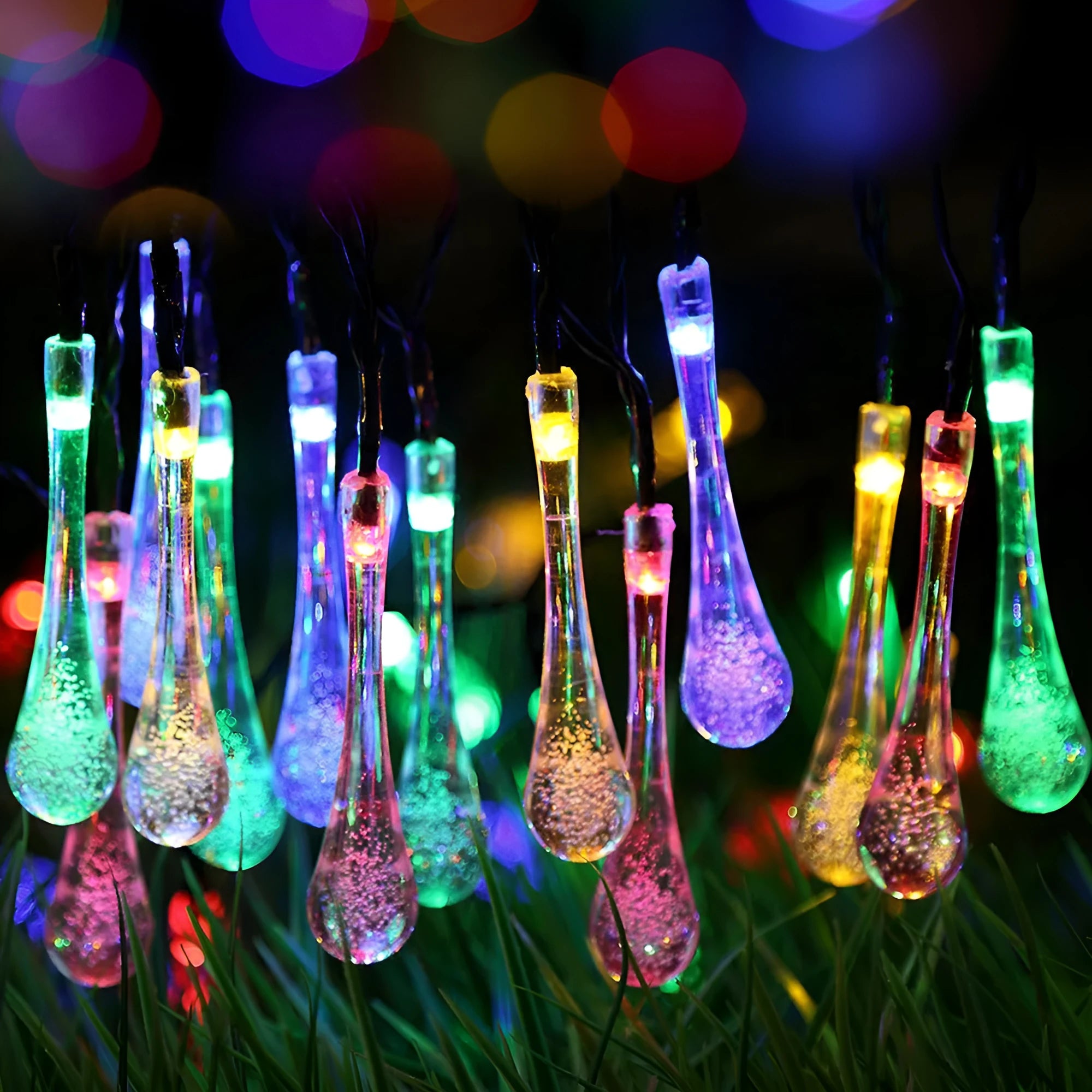 6.5 metre long solar-powered LED garden string lights with white bubble drop shaped lamps on a green lawn