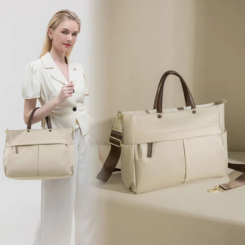 Women's Oxford cloth laptop briefcase showing elegant black colour with multiple open pockets and portable handle