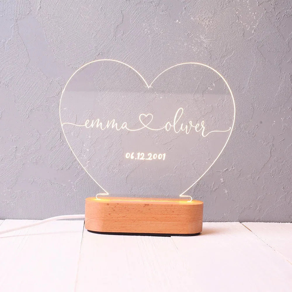 Custom acrylic LED night light displaying engraved names and dates on clear 20cm by 11.5cm panel
