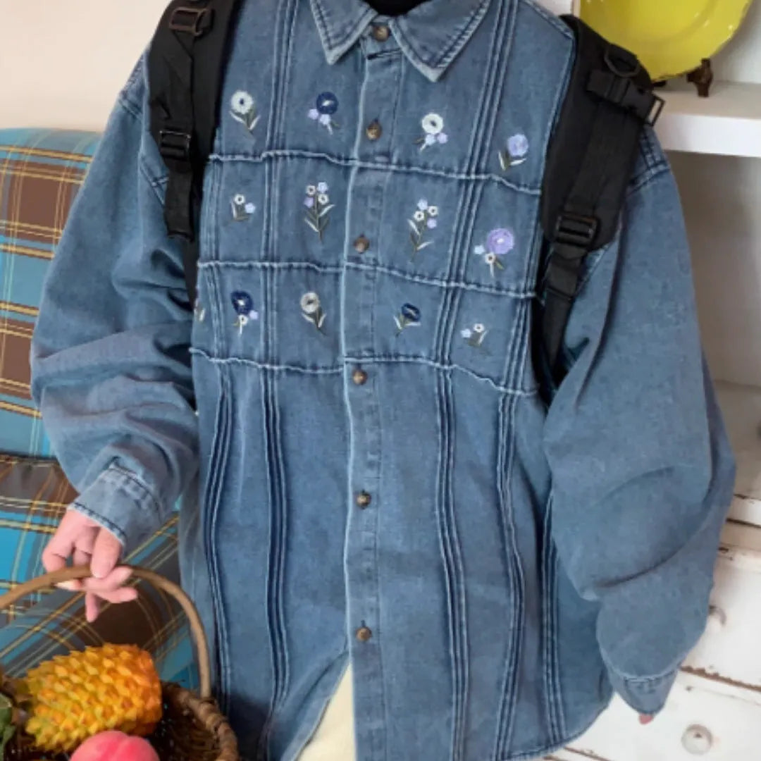 Washed blue long sleeved denim shirt with small floral pattern and pleated details on front