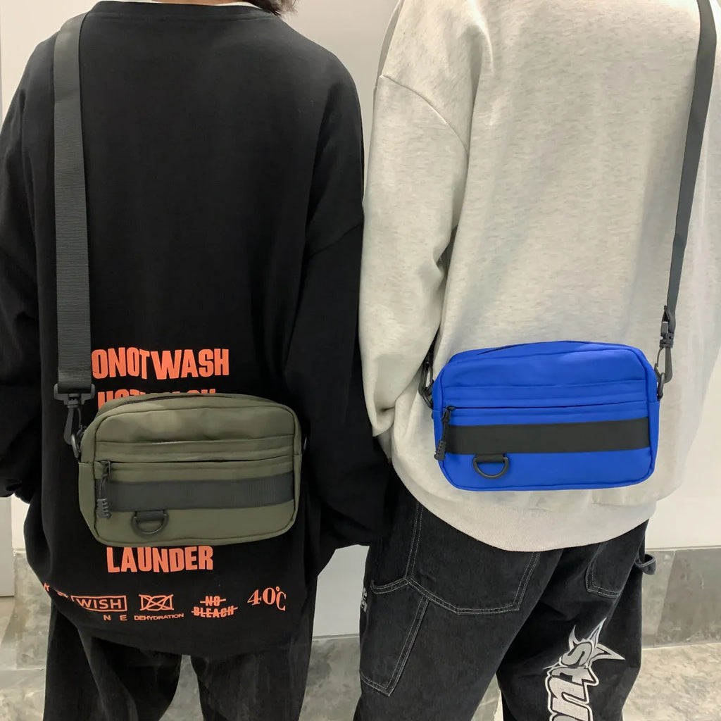 Men's solid colour polyester and nylon crossbody messenger bag shown in black, blue, green, or white.