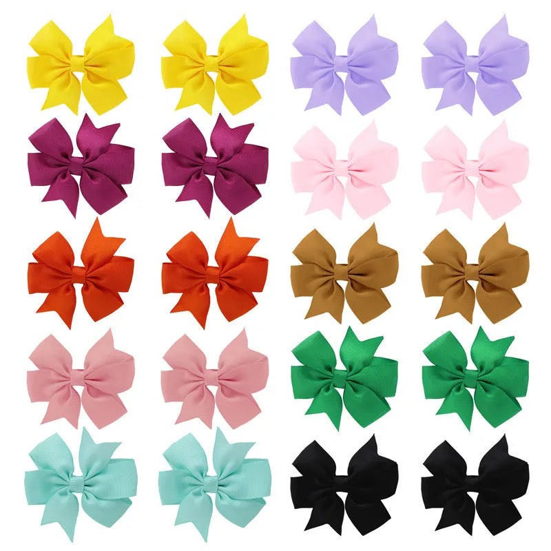 Set of 20 handmade grosgrain ribbon hair bows with alligator clips in assorted colours, each 3 inches long, on a white background