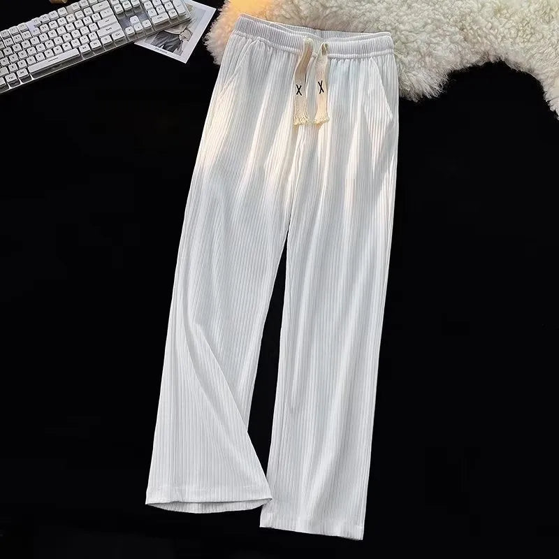 Men's loose straight cotton casual trousers in white, front view, on a model