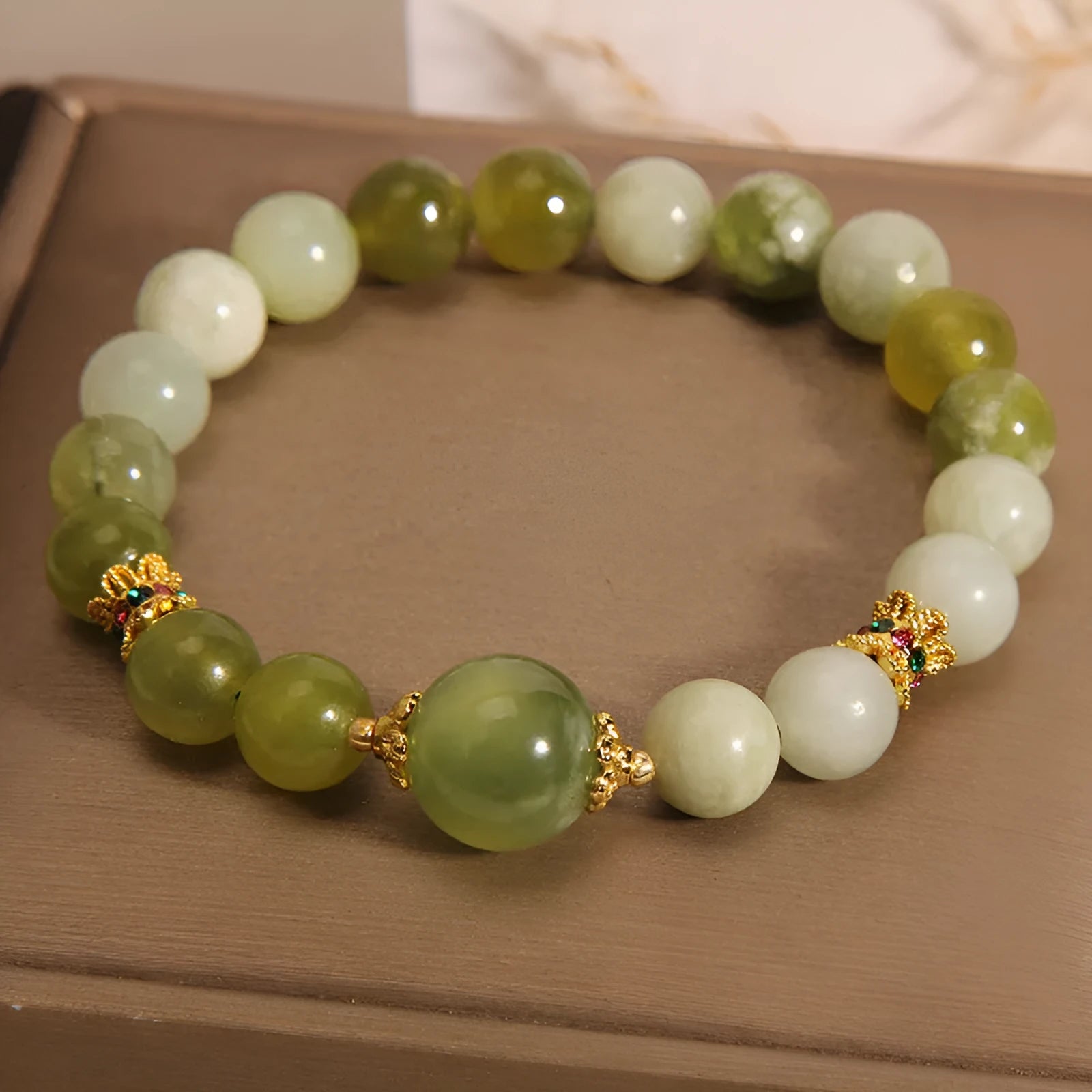 Women's bracelet in Xiuyan jade green with original design on display