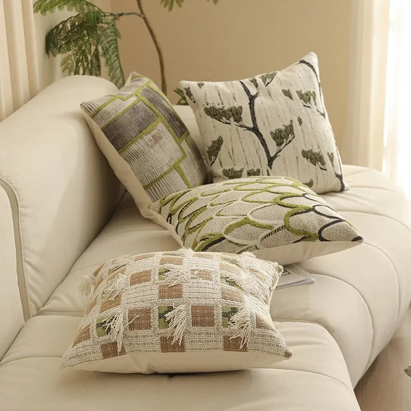 Close-up of a square jacquard pillow cover with a woven retro floral pattern in various colours, sized 45 by 45 cm.