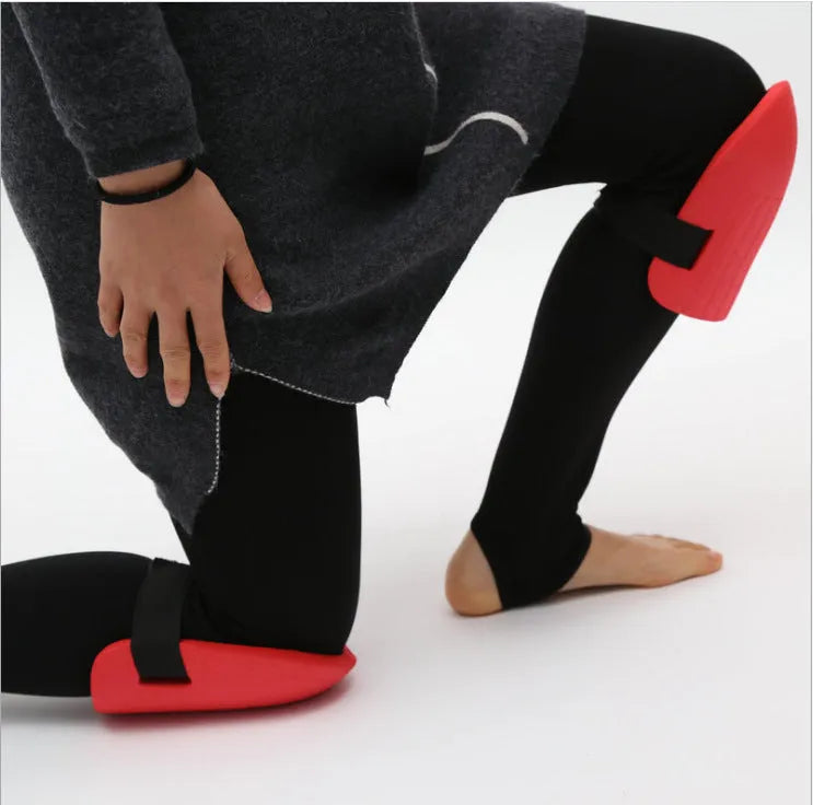A pair of thick black EVA foam knee pads for gardening and DIY work.