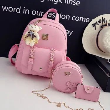 Three-piece women's bag set showing backpack, floral shoulder bag, and card holder in matching colour