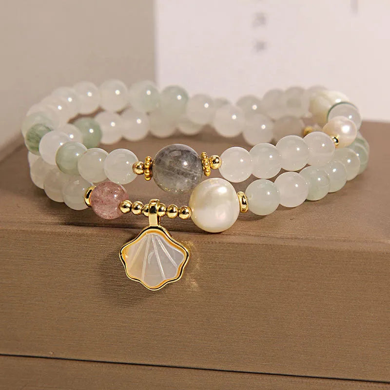 Women's crystal bracelet with green ginkgo leaf pendant, gold accents and rhinestones