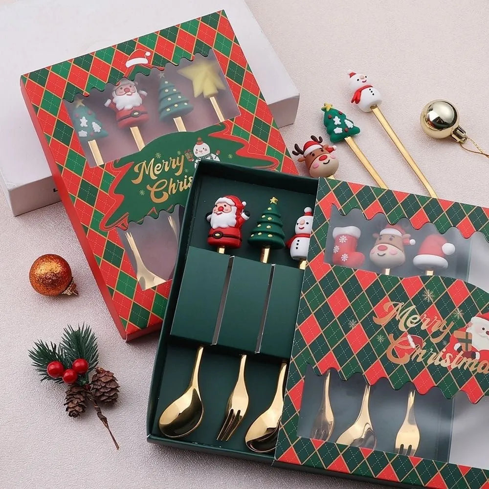 Four stainless steel Christmas spoons and forks with red handles showing Christmas tree and snowman designs on a white background