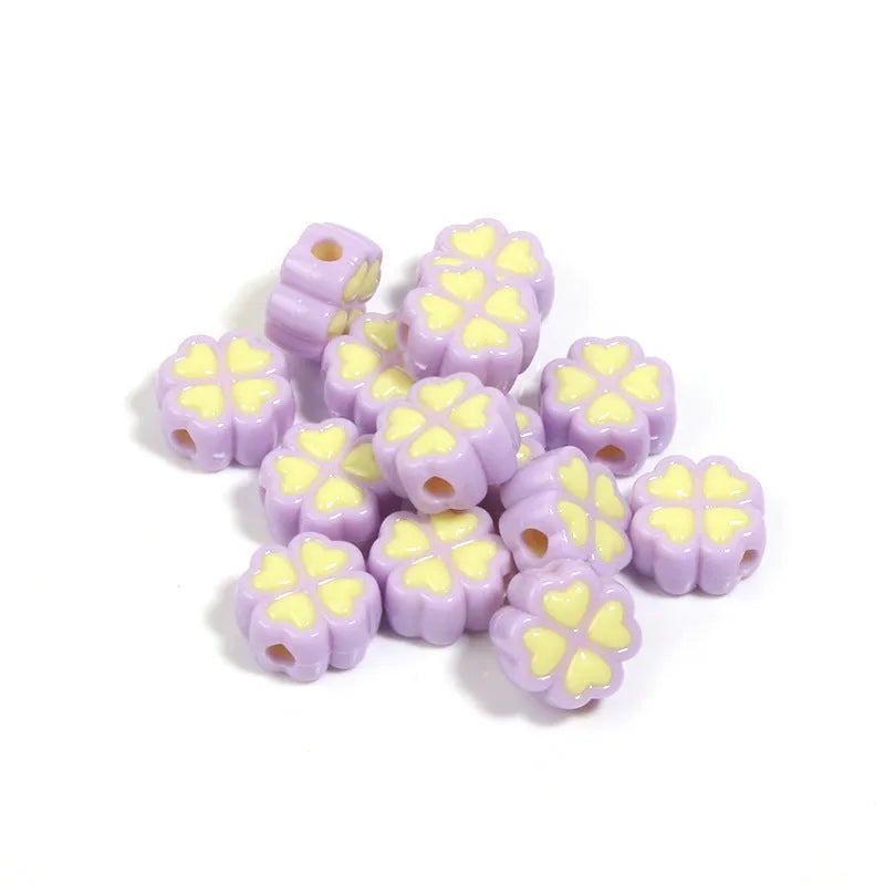 Acrylic four-leaf clover craft beads with love pattern in mixed colours showing frosted finish
