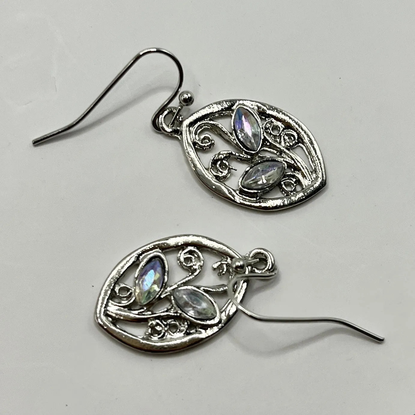 Silver alloy leaf-shaped earrings with embedded colourful moonstone gemstones and diamond-cut treatment