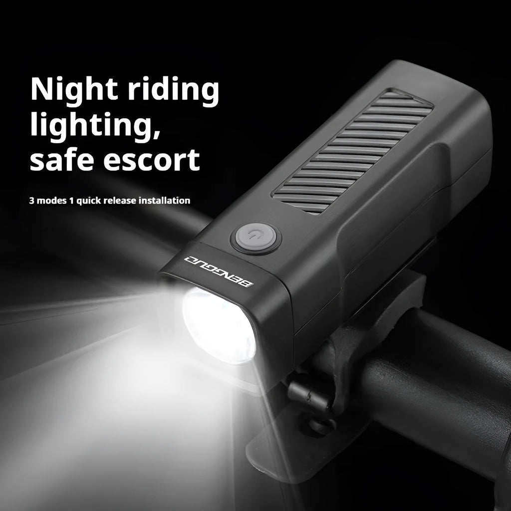 Black bicycle headlight with LED lens mounted on handlebars via a quick-release strap bracket.